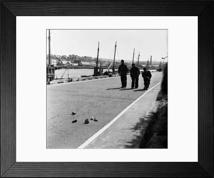 Framed Print : Peel Castle on St Patricks Isle, Isle of Man serves as a background to a Jeu de Boule