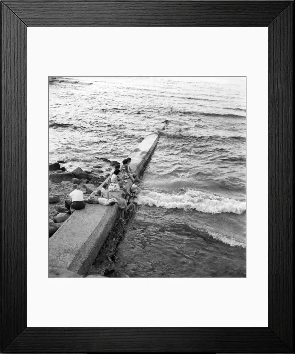 Framed Print : Holidaymakers on a sewerage pipe on the beach at Tynemouth near Newcastle Upon Tyne