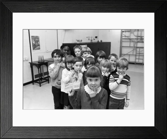 Framed Print : Shhh... says five-year-old Emily Fozzard as she hands over this £ Framed Print : Shhh... says five-year-old Emily Fozzard as she hands over this £
