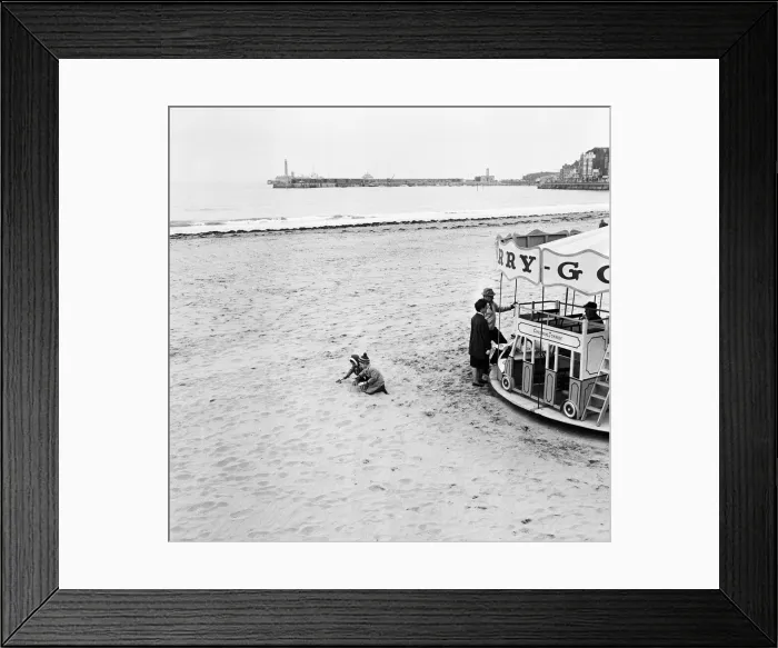 Framed Print : Scenes in Margate, Kent, during Good Friday. Two toddlers playing on the beach besides a Framed Print : Scenes in Margate, Kent, during Good Friday. Two toddlers playing on the beach besides a