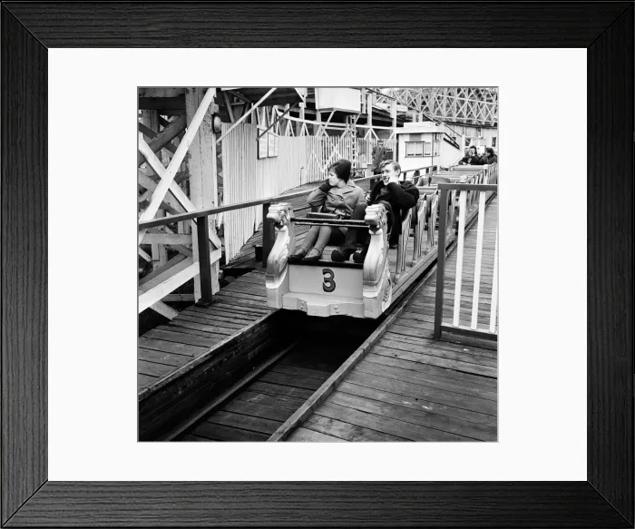 Framed Print : Scenes in Margate, Kent, during Good Friday. A couple on a funfair ride. 27th March 1964 Framed Print : Scenes in Margate, Kent, during Good Friday. A couple on a funfair ride. 27th March 1964