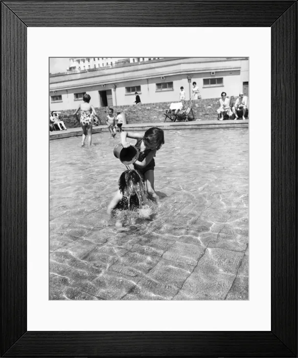 Framed Print : Hot weather scenes in Margate, Kent. Two young children playing in a paddling pool Framed Print : Hot weather scenes in Margate, Kent. Two young children playing in a paddling pool