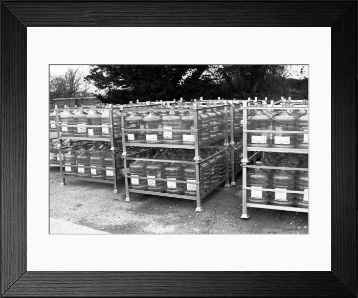Framed Print : Aqua Trading Company 6th March 1989. Demijohns waiting to be filled for transport to Framed Print : Aqua Trading Company 6th March 1989. Demijohns waiting to be filled for transport to