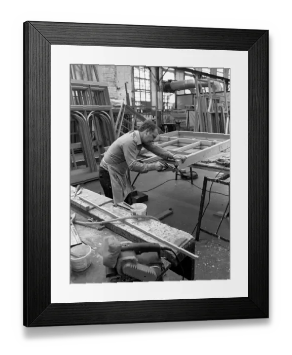Framed Print : Amdega Conservatories. Joiner puts the finishing touches to one of the joints of a