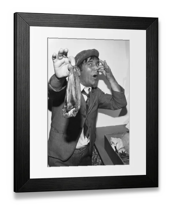 Framed Print : Comedian Norman Wisdom seen here in the persona of hapless on screen character Norman