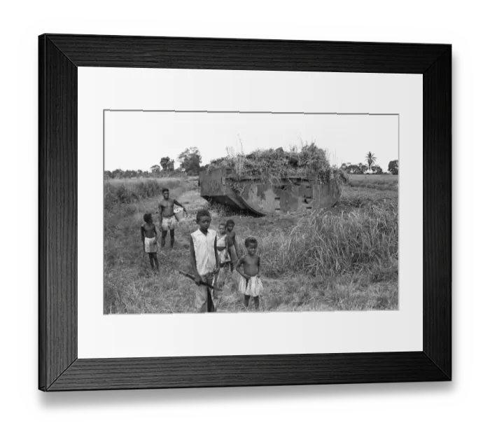 Framed Print : Children playing near a weed strewn Buffalo LVT American tank in a potato field Framed Print : Children playing near a weed strewn Buffalo LVT American tank in a potato field