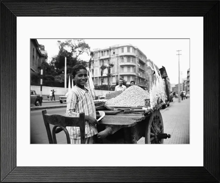 Framed Print : A child street vendor selling chick peas on the streets of Alexandria. 29th May 1976 Framed Print : A child street vendor selling chick peas on the streets of Alexandria. 29th May 1976