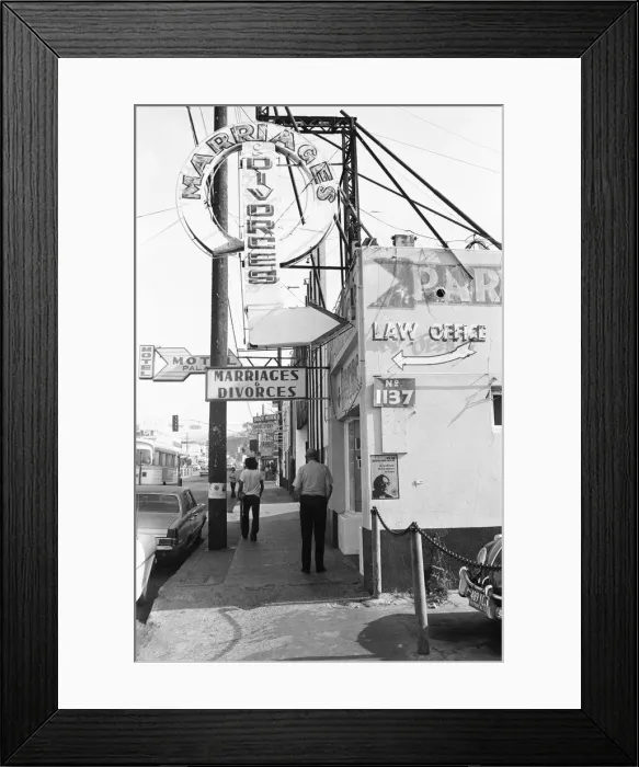 Framed Print : A street in Tijuana, Mexico, with neon signs for bars and quick marriages and divorces