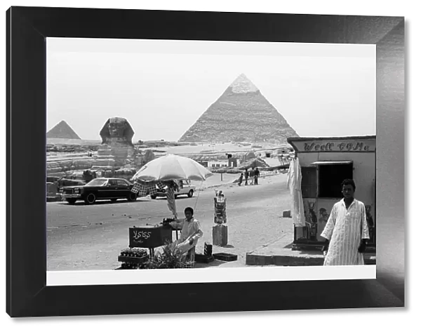 Two local egyptians seen here at the Great Pyramid and Sphinx of Giza selling postcards