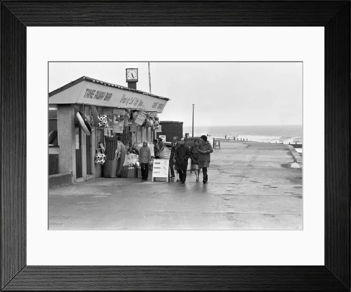 Framed Print : A family making the most of a walk on Hornsea sea front despite the weather conditions Framed Print : A family making the most of a walk on Hornsea sea front despite the weather conditions