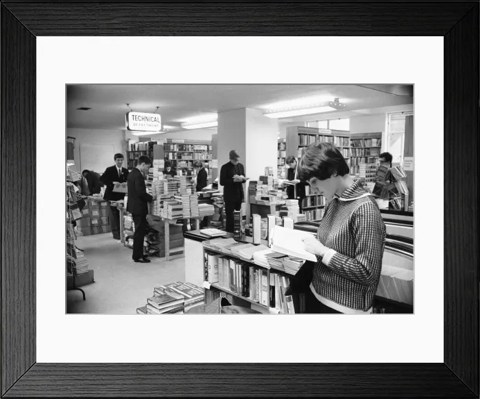 Framed Print : Young lady reading a text book in the Technical book department at Foyles bookshop in Framed Print : Young lady reading a text book in the Technical book department at Foyles bookshop in