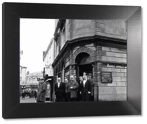A group of men standing outside the Ministry of Labour on the High Street, Barnstaple