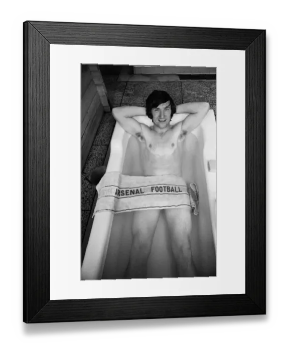 Framed Print : Arsenal footballer George Armstrong pictured in the bath at Highbury football ground