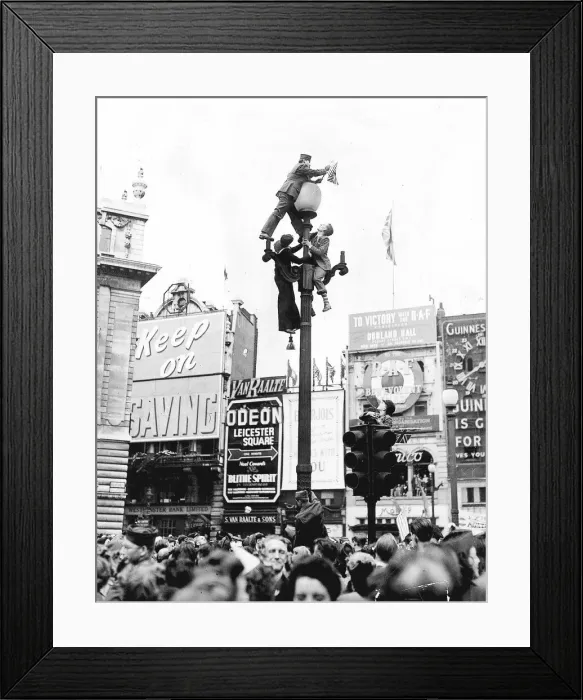 Framed Print : Climbing a lamppost in Piccadilly Circus London to get a better view of the VE-Day Framed Print : Climbing a lamppost in Piccadilly Circus London to get a better view of the VE-Day