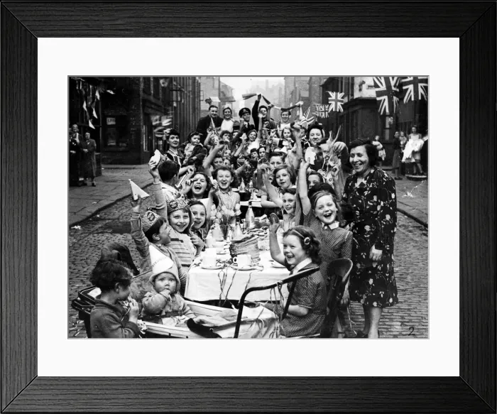 Framed Print : Streamers and flags are waved by residents of this Manchester street when fifty children Framed Print : Streamers and flags are waved by residents of this Manchester street when fifty children