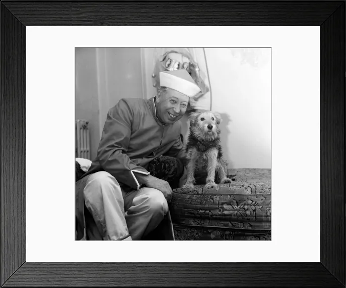 Framed Print : The show must go on, says George Formby, appearing as Mr Wu in Aladdin