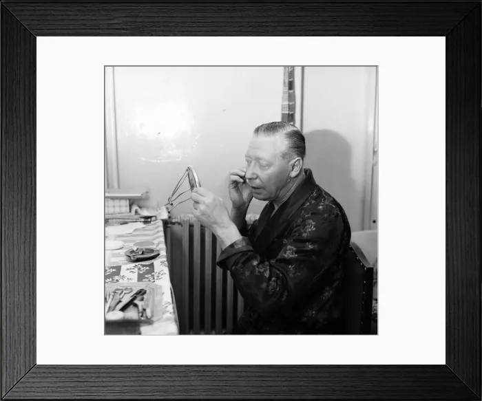 Framed Print : The show must go on, says George Formby, appearing as Mr Wu in Aladdin