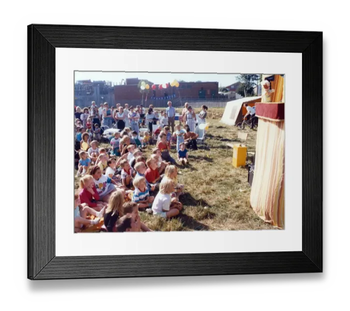 Framed Print : Youngsters are entertained by a Punch and Judy show at Carlin How carnival