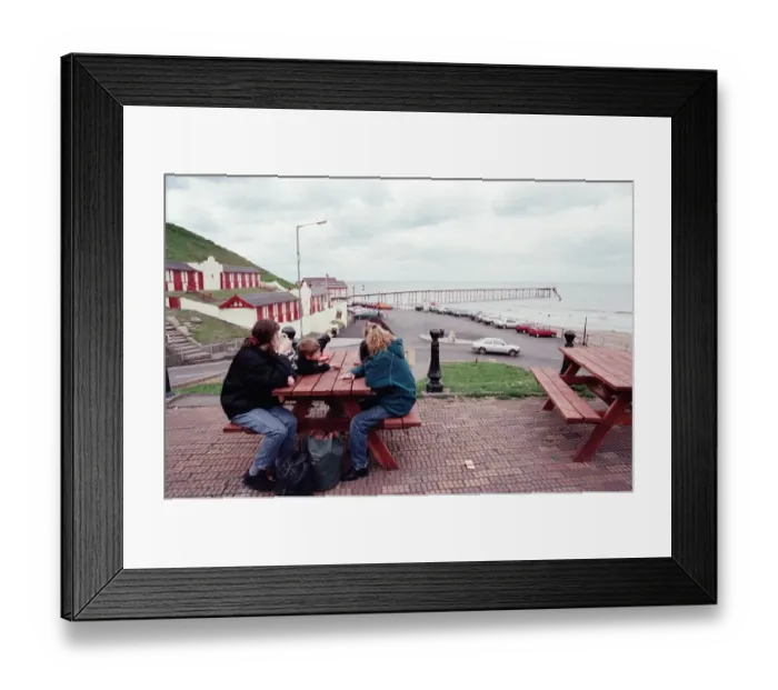 Framed Print : Families sitting on a bench looking at Saltburn pier, North Yorkshire. 9th May 1996