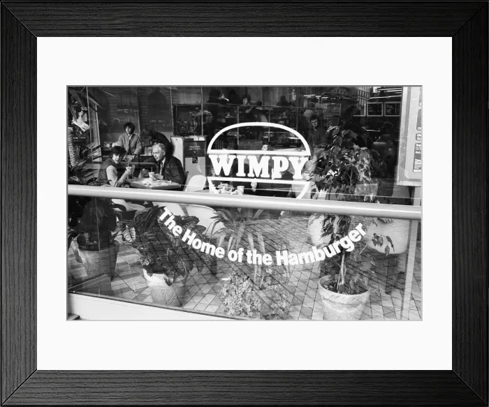 Framed Print : Customers enjoying a lunchtime burger at at Wimpy restaurant in London Framed Print : Customers enjoying a lunchtime burger at at Wimpy restaurant in London