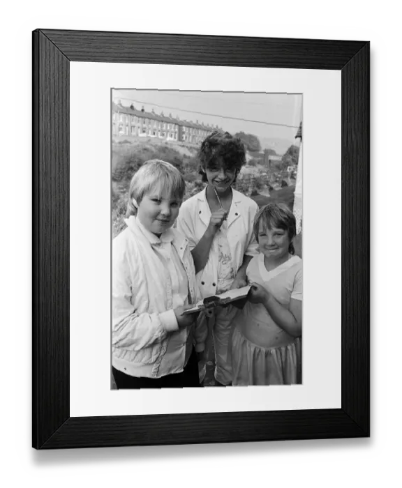 Framed Print : Checking the clues before setting out on a treasure hunt at Marsden are (from left