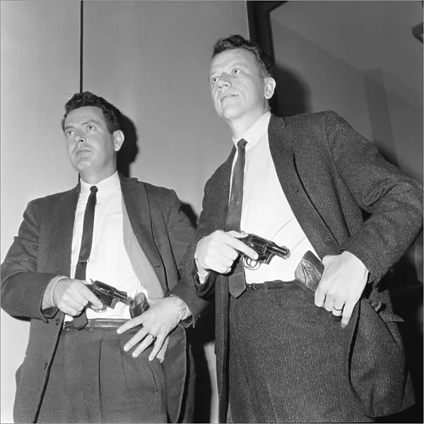San Francisco detectives Inspector James Bohm (left) and Lester Gance seen here putting