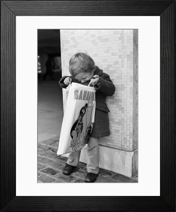 Framed Print : A Young Christmas shopper in Birmingham, West Midlands. 20th December 1975