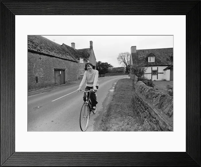 Framed Print : Pam Ayres riding her bicycle near her home in a village in Oxfordshire. 12th May 1977