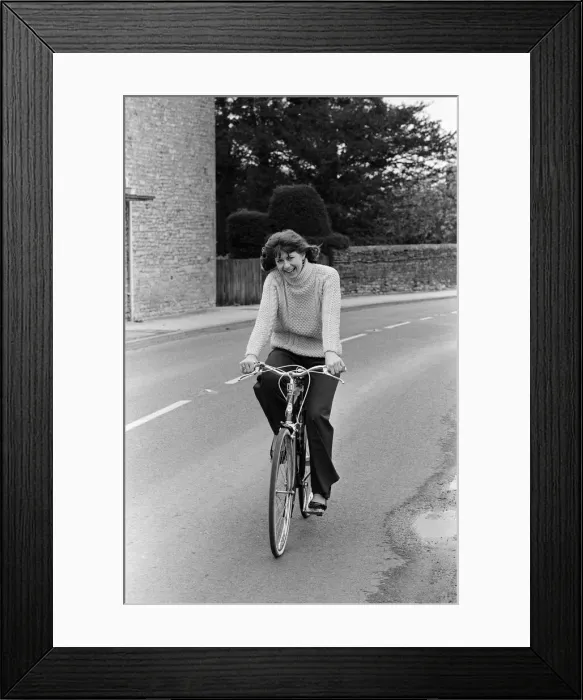Framed Print : Pam Ayres riding her bicycle near her home in a village in Oxfordshire. 12th May 1977 Framed Print : Pam Ayres riding her bicycle near her home in a village in Oxfordshire. 12th May 1977