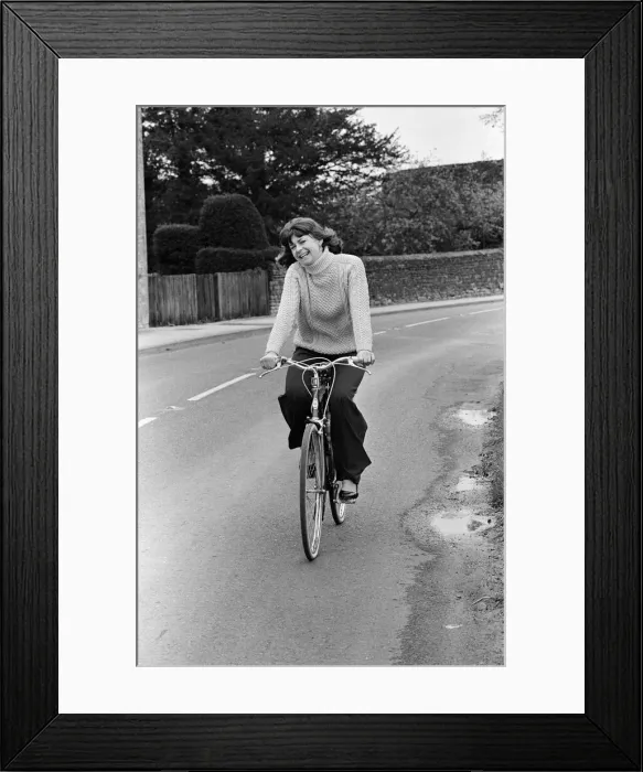 Framed Print : Pam Ayres riding her bicycle near her home in a village in Oxfordshire. 12th May 1977 Framed Print : Pam Ayres riding her bicycle near her home in a village in Oxfordshire. 12th May 1977