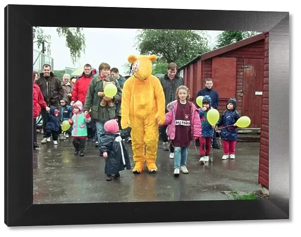 Pudsey Bear leads the toddlers round the park during the Great Toddle for Children in