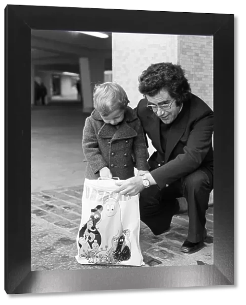 A Young Christmas shopper with his dad in Birmingham. 20th December 1975