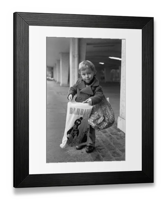 Framed Print : A Young Christmas shopper in Birmingham. 20th December 1975 Framed Print : A Young Christmas shopper in Birmingham. 20th December 1975