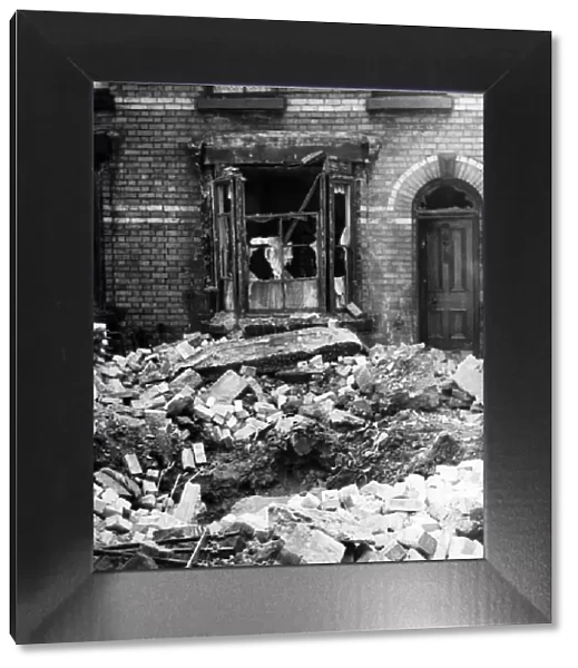 Bomb damage in Liverpool. A large crater in Stevenson Street, Liverpool