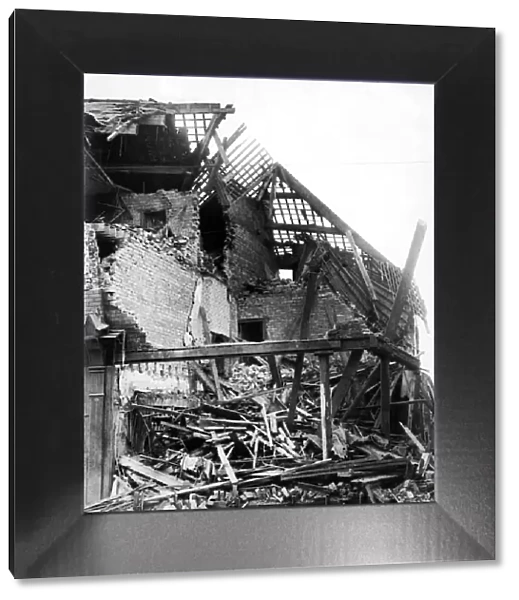 Bomb damage in Wavertree Road, Liverpool. This shop and house was the victim of a direct