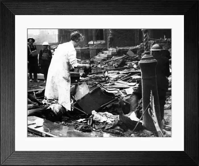 Framed Print : Bomb damage in Liverpool during the Second World War. A woman searches the wreckage of