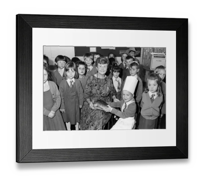 Framed Print : Mrs Rita Manchester receives a loaf of bread from six-year old Angela Chapman after a