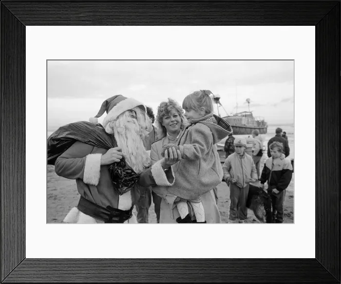 Framed Print : Father Christmas arrives to Newbiggin by lifeboat. Northumberland, December 1985