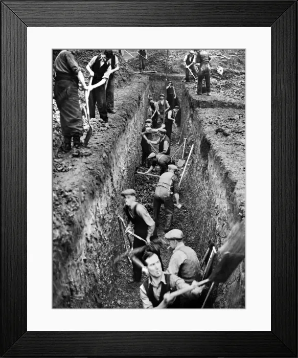 Framed Print : Men digging deep trenches in Birkenhead Park, which will become shelters Framed Print : Men digging deep trenches in Birkenhead Park, which will become shelters