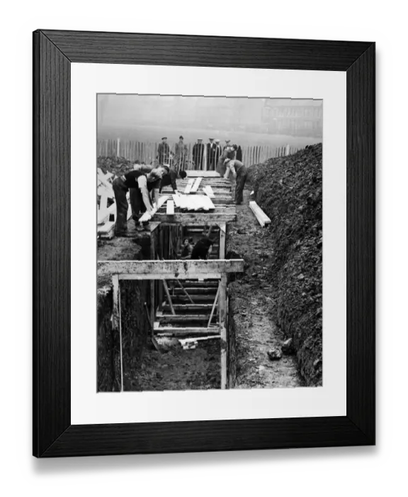 Framed Print : Timbering up the deep trenches in Birkenhead Park. The shelters will have seats along