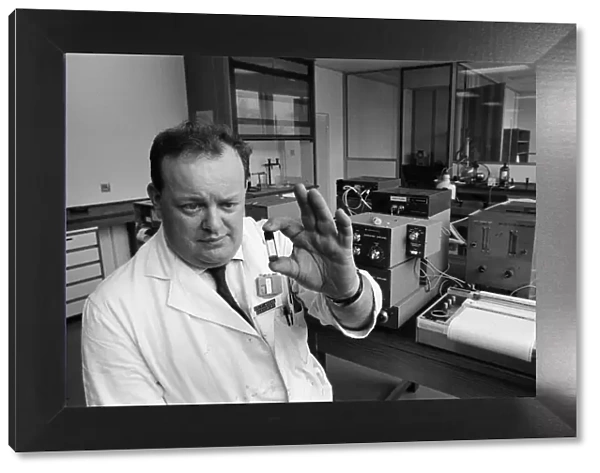 Dr. Frank Skuse studies a blood sample for alcoholic content at the North West Forensic
