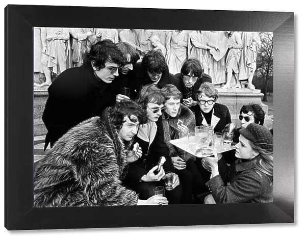 Young pop stars gathered at the Albert Memorial in London for a bread and water lunch to draw attention to Oxfams Christmas appeal. Pictured, Elaine Osborn serving bread and water to (left to right back row) Syd Barrett, Barry Fantoni, Gordon Waller