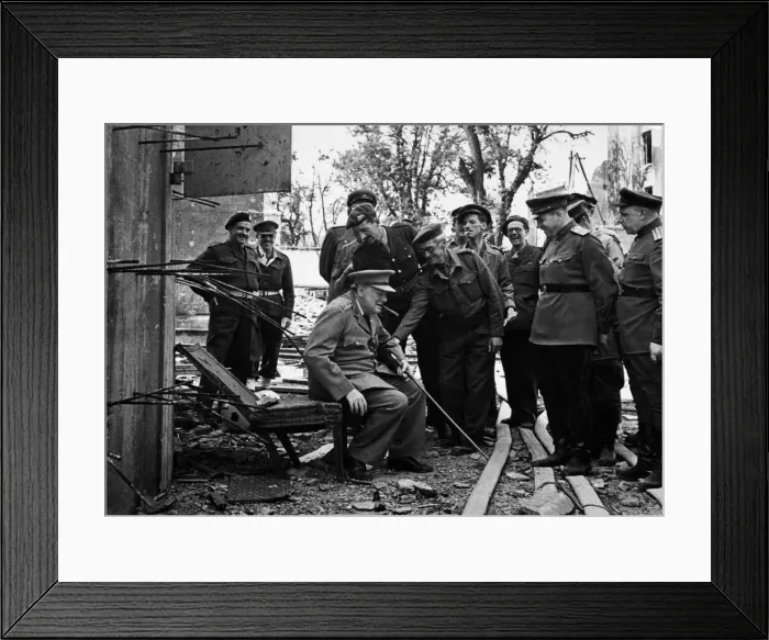 Framed Print : Prime Minister Winston Churchill rests on one of the damaged chairs from the bunker in Framed Print : Prime Minister Winston Churchill rests on one of the damaged chairs from the bunker in