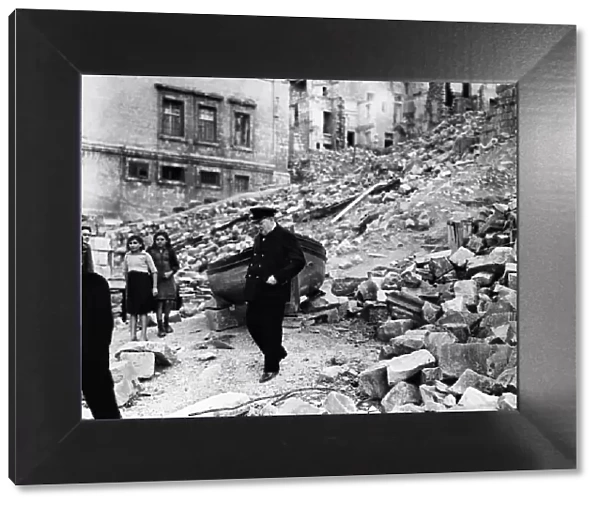 British Prime Minister Winston Churchill surveys the destruction in the dockyard area of