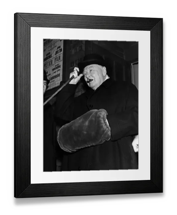 Framed Print : Winston Churchill wearing a hand muff as he leaves the Scala theatre in London where he Framed Print : Winston Churchill wearing a hand muff as he leaves the Scala theatre in London where he