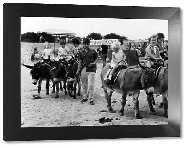 Young children enjoying donkey rides on the beach. 6th August 1968