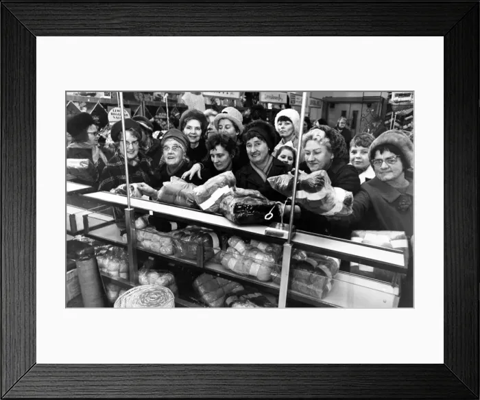 Framed Print : The sales rush is on and eager housewives crowd around the counter in a Liverpool store
