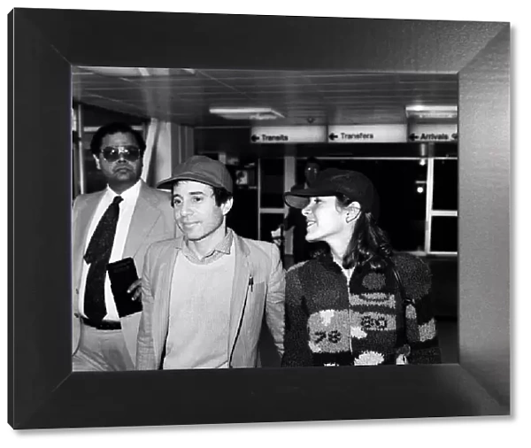 American musician Paul Simon and actress Carrie Fisher at Heathrow airport. 24th May 1980