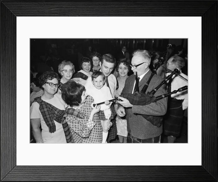 Framed Print : Piper plays for a small group of people attending a New Years Dance at the Regis Hall Framed Print : Piper plays for a small group of people attending a New Years Dance at the Regis Hall