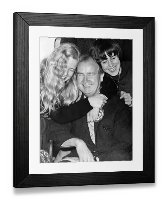 Framed Print : Gwynfor Evans receives a hug from his daughters Meiniri (left) and Branwen (right)